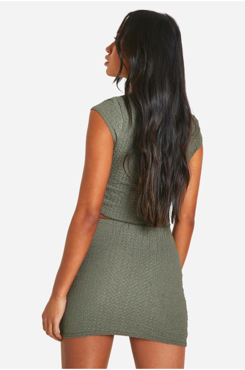 Міні-спідниця з фактурним зеленим подолом