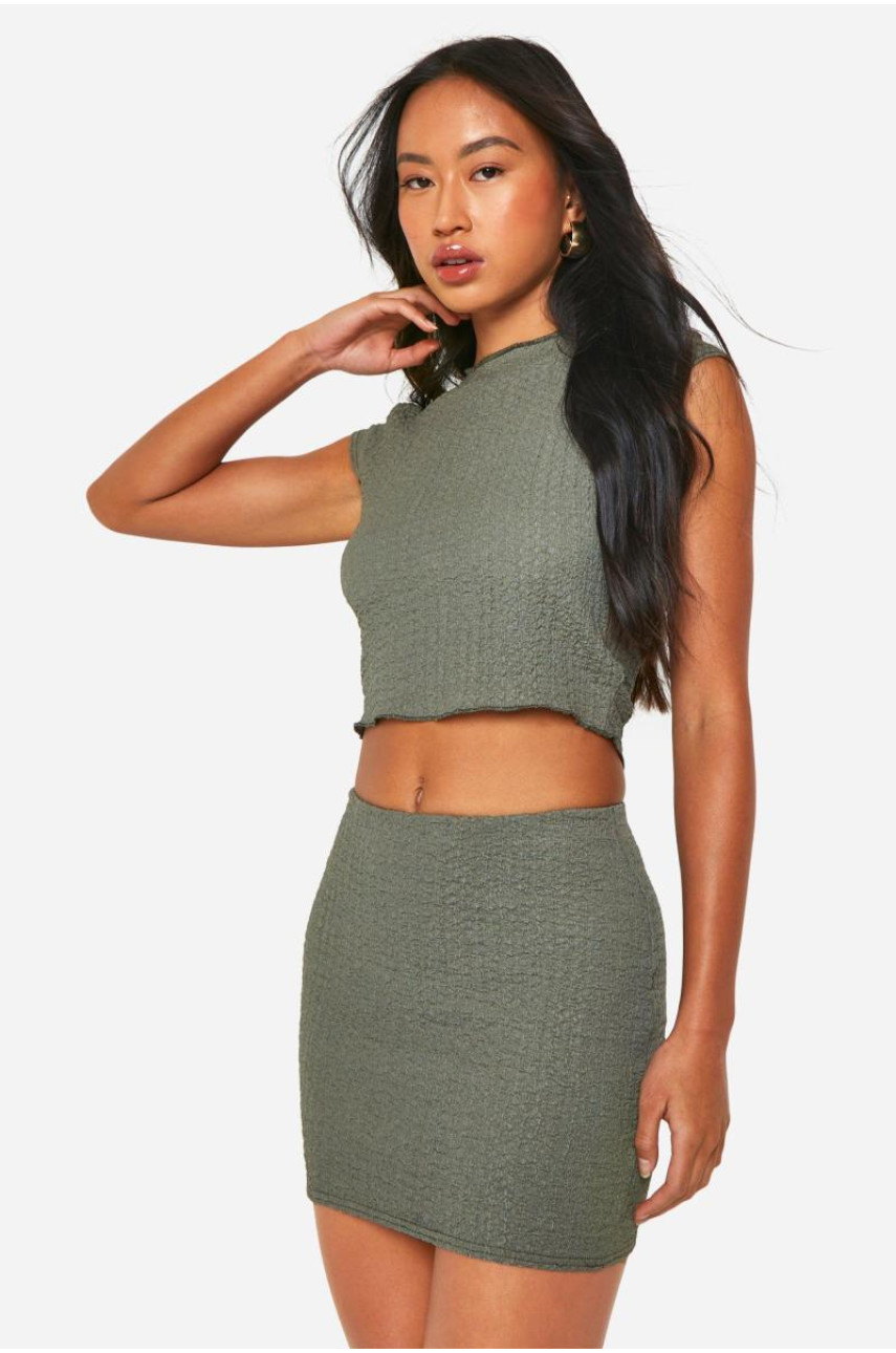 Міні-спідниця з фактурним зеленим подолом