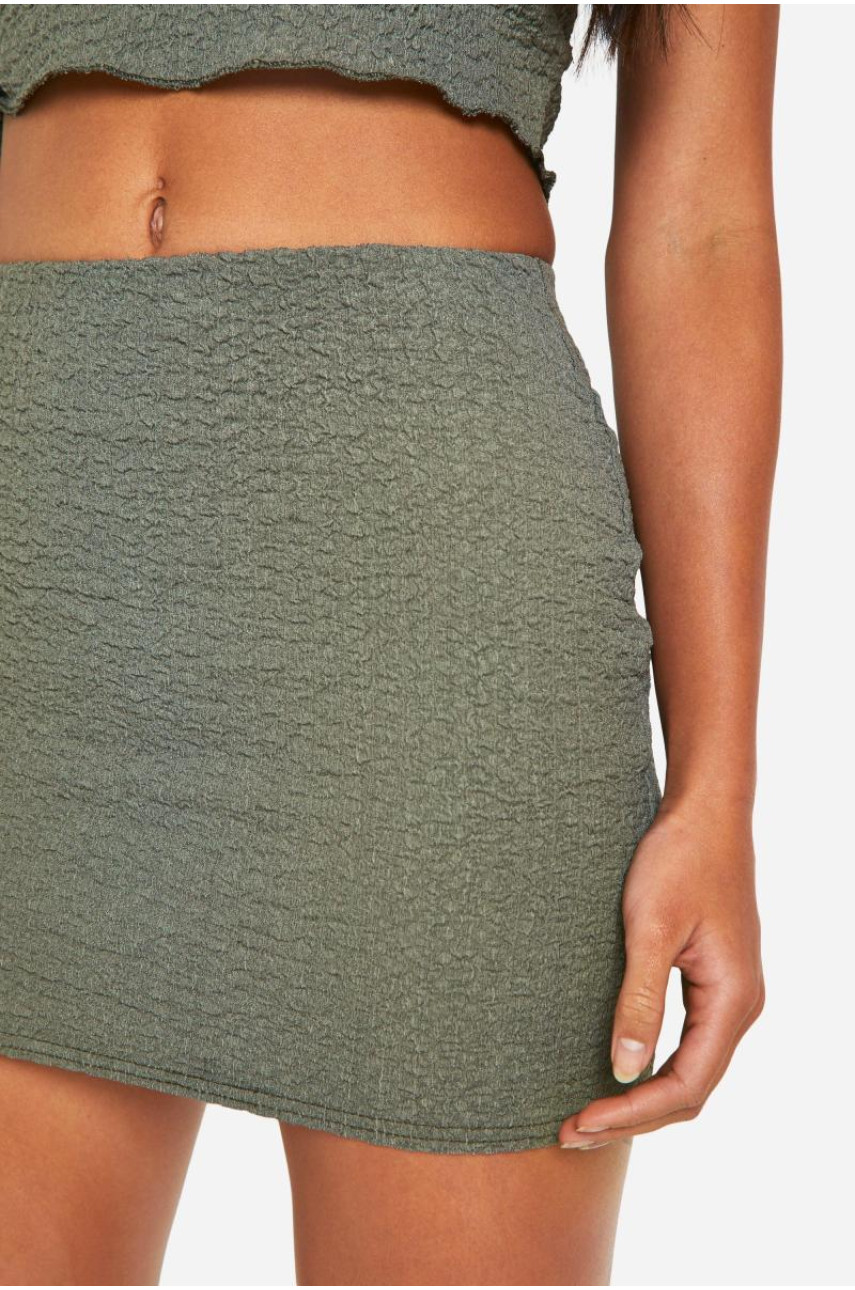 Міні-спідниця з фактурним зеленим подолом